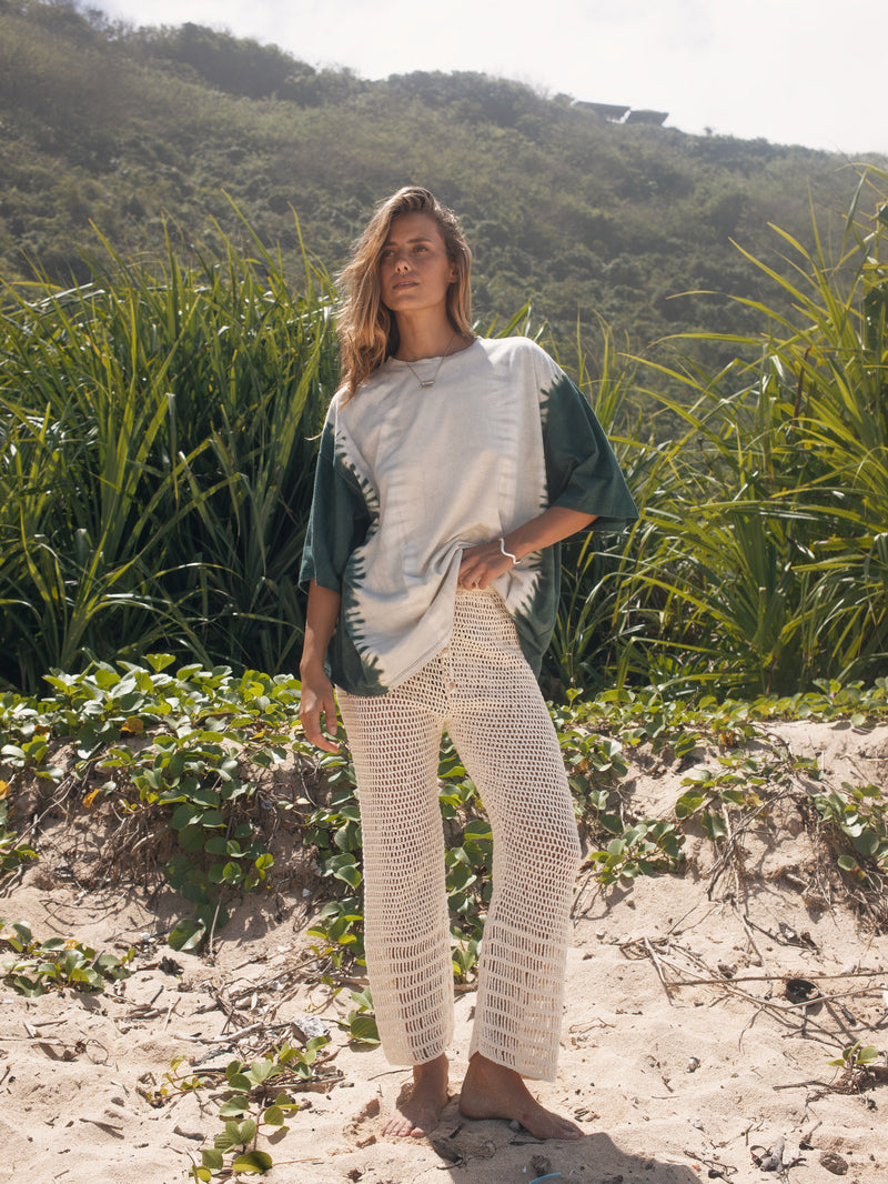 Model wearing cotton hemp green and white tie dye tee and crochet pants