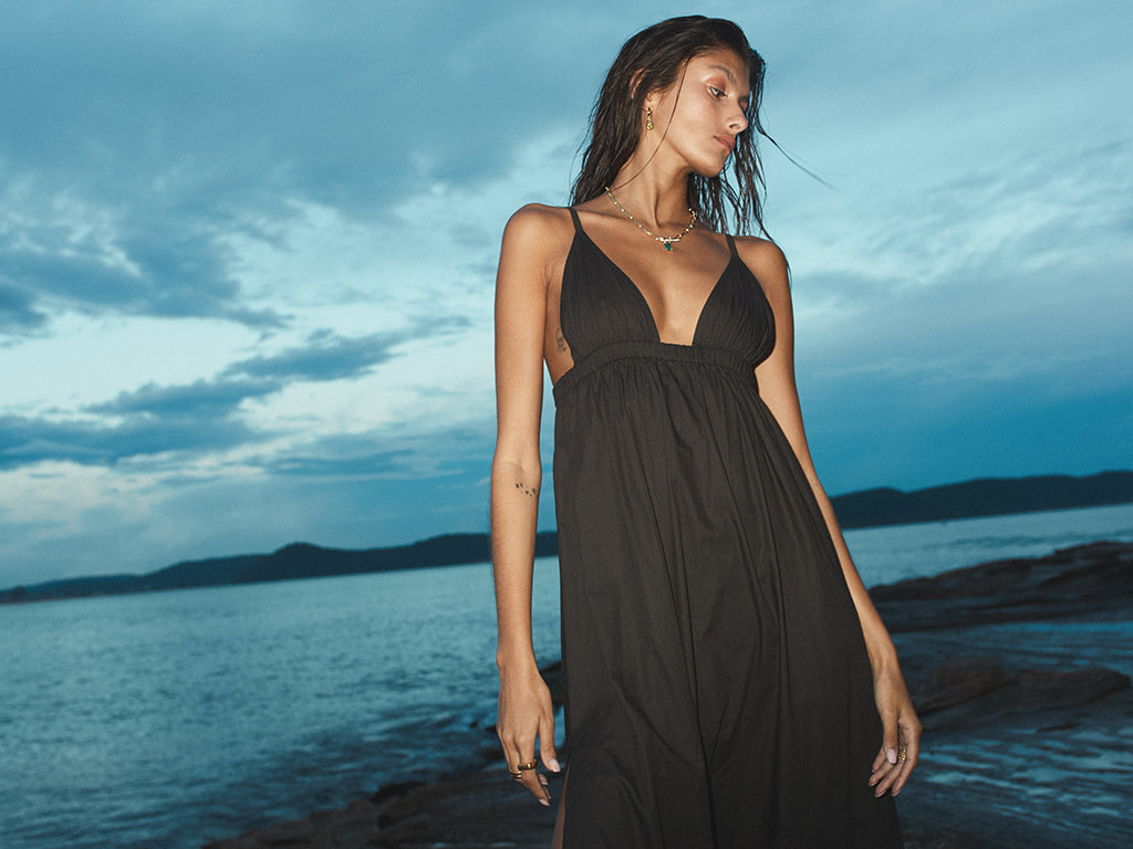 girl wearing black maxi dress on beach