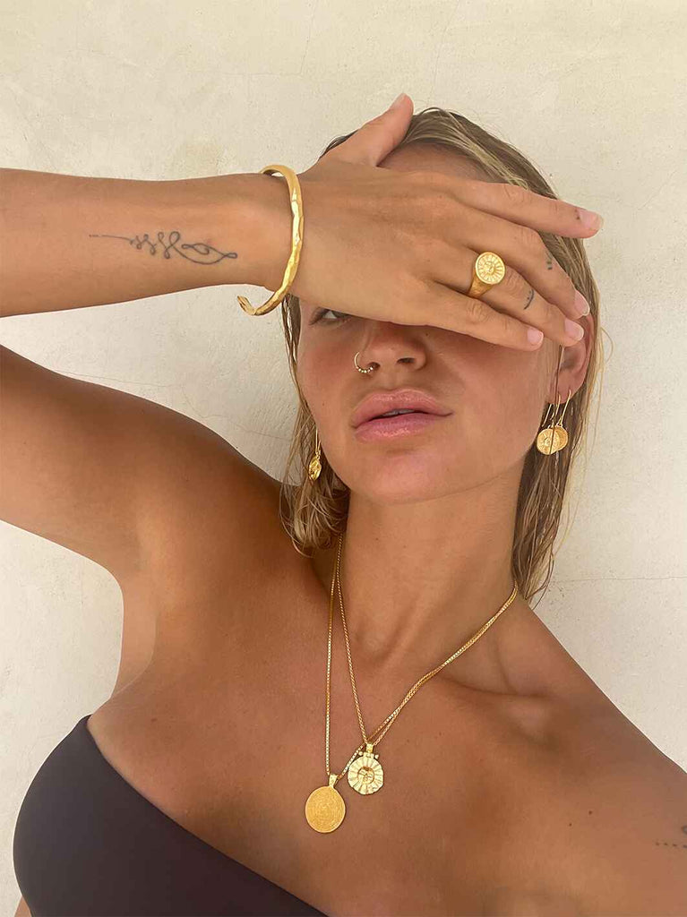 model wearing gold jewellery layered