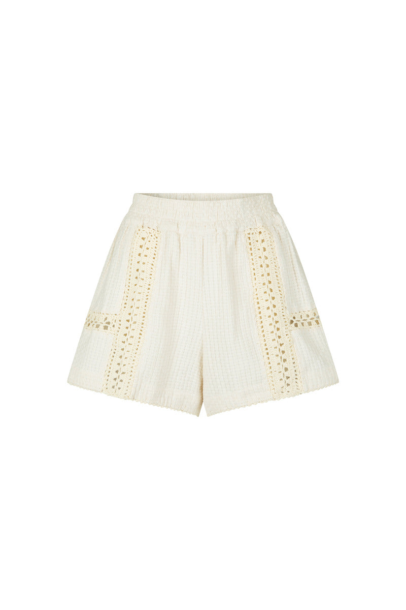 White shorts with decorative crochet cut-out details on a white background