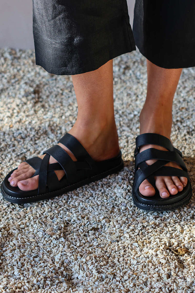 black leather sandals feet view