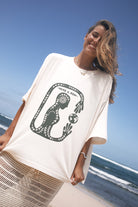 Woman wearing a white t-shirt with a artist print design 