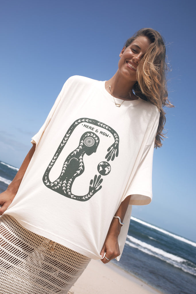 Woman wearing a white t-shirt with a artist print design 