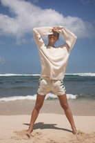 Model wearing beige cotton sweater with green cotton hemp tie dye shorts