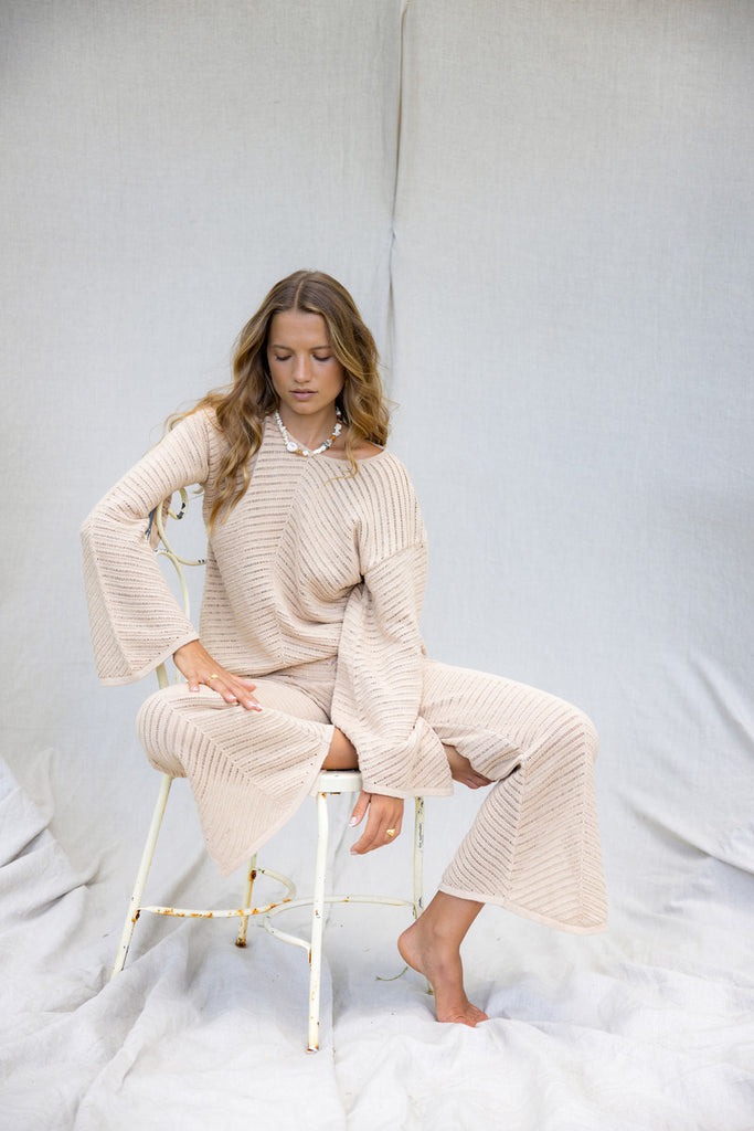 model wearing matching cotton beige knit top and pant set