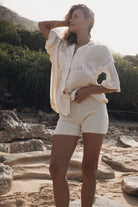 Womens cream coloured viscose lace shirt, styled with cream knit short, front view