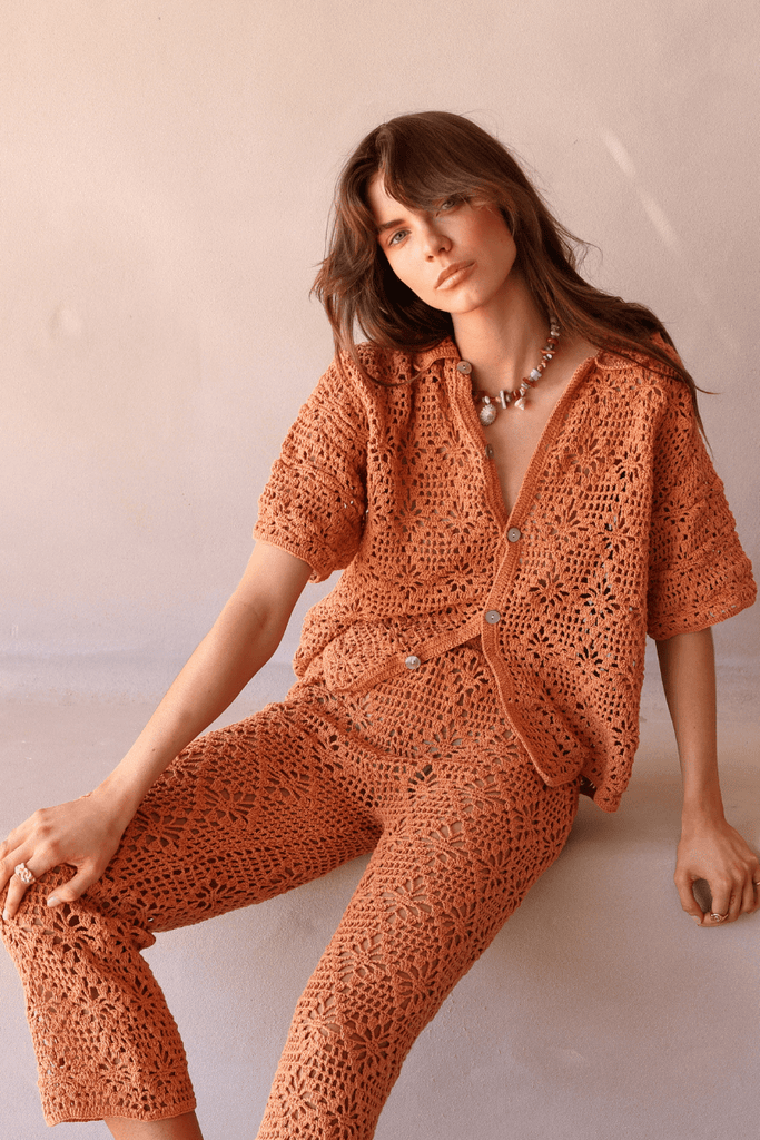 model wearing rust crochet shirt and pant set 