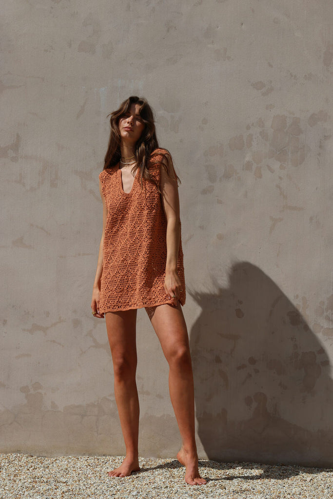 model wearing rust crochet mini dress