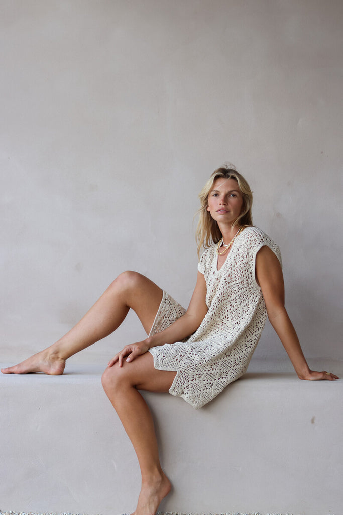 model wearing beige crochet mini dress