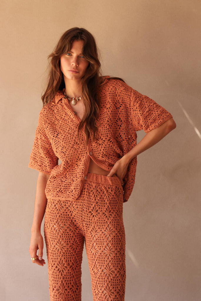 model wearing elasticated waist rust crochet pant 