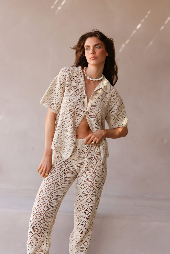 model wearing beige crochet shirt and pant set 