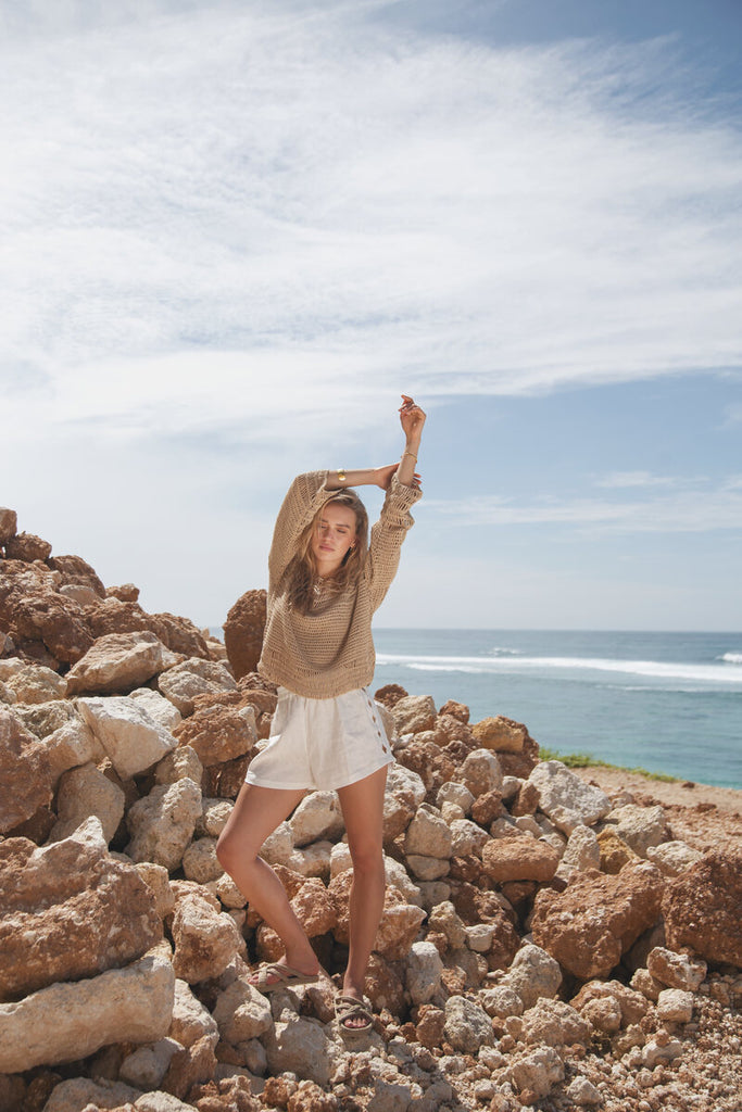 model wearing white linen short with crochet top