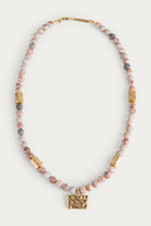 beaded necklace with gold organic shaped pendant