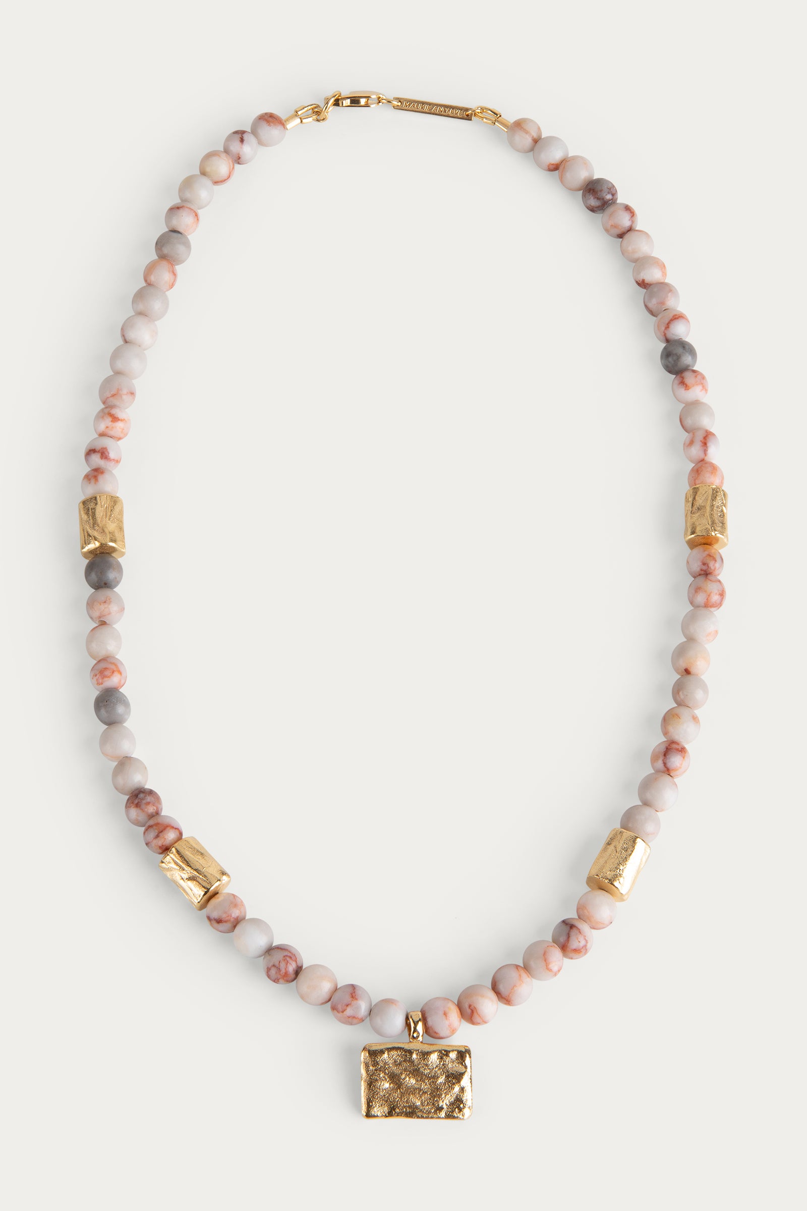 beaded necklace with gold organic shaped pendant