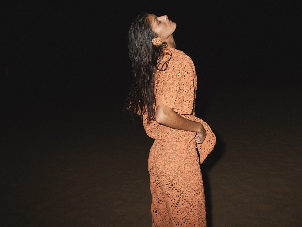 lady in orange crochet top and pants