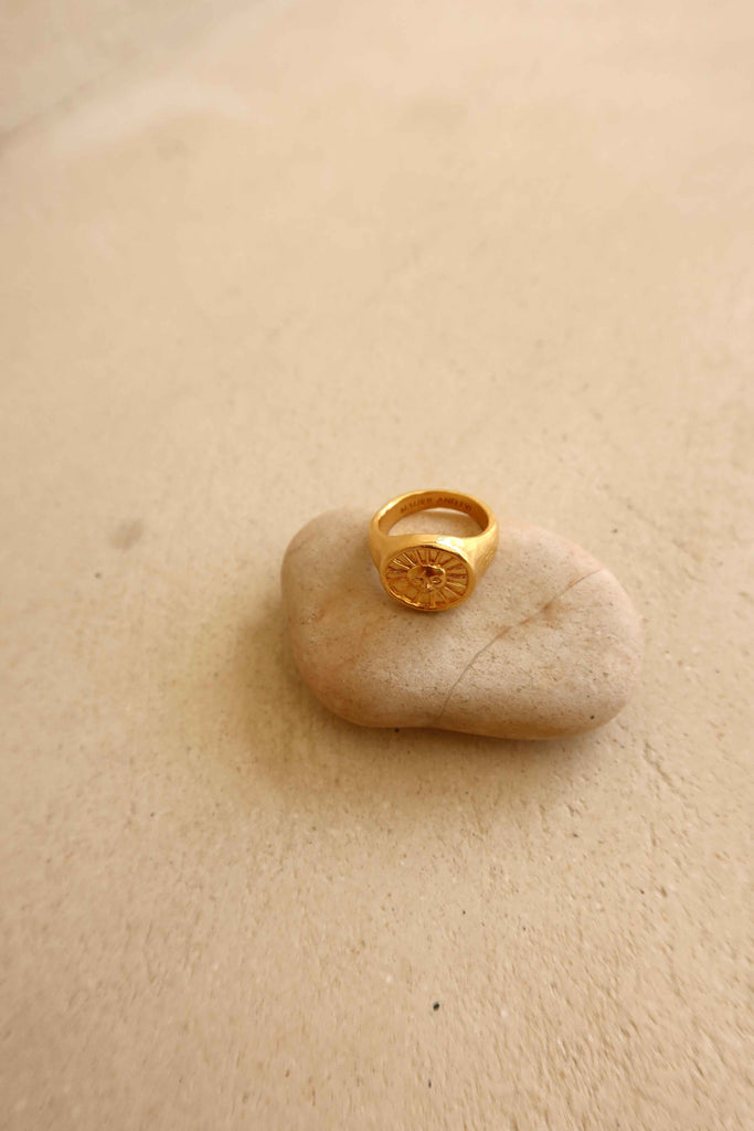 gold plaited ring with engraved sun motif 