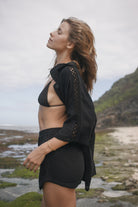 Womens black cotton crochet shirt, styled with matching short, side view