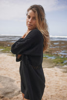 Womens black cotton crochet mini dress, side view