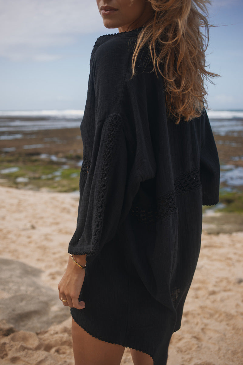 Womens black cotton crochet mini dress, back view