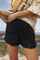 Womens black cotton crochet short, styled with tie dye shirt, front view