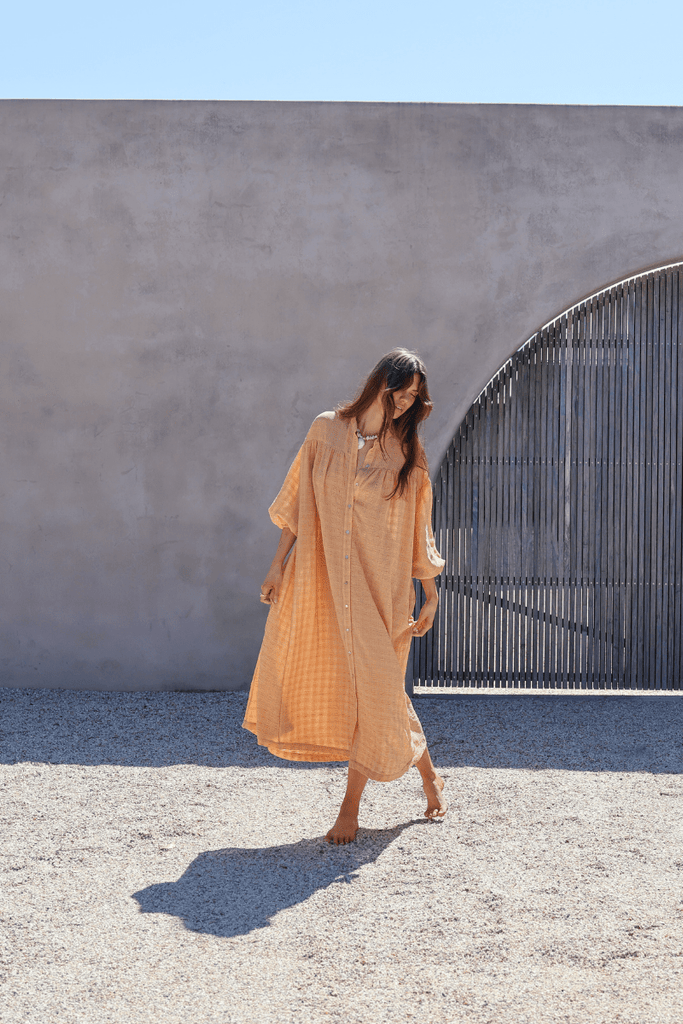 model wearing button up maxi dress in marigold 