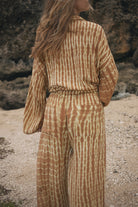 Womens tan cotton tie dye pant, styled with matching shirt, back view