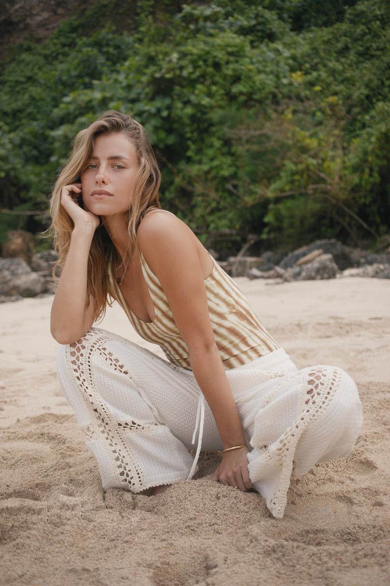 Womens cotton tie dye bodysuit, styled with cream crochet pant, front view
