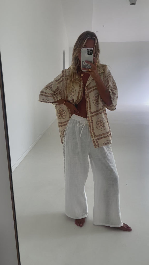 white cotton lace pant and artist print shirt