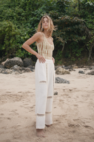 Womens tan cotton tie dye bodysuit, styled with cream pant, side view